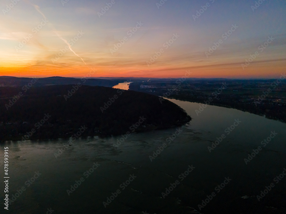 Aerial drone photo over river during sunset.