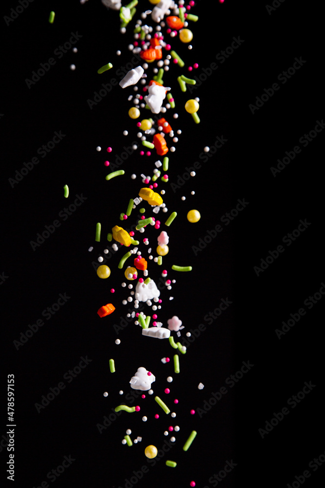 Sprinkles falling on a dark background
