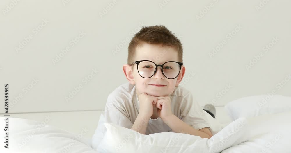 Video „Portrait child boy With Glasses Looking at Camera. Laughs