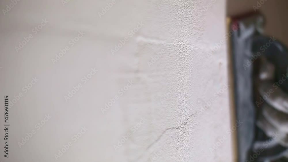 Sanding of walls with sandpaper after treatment with dry building mixes