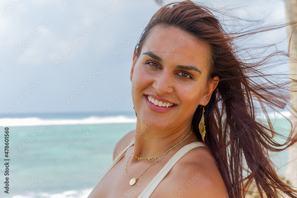 Portrait of a Latin happy woman in a Caribbean beach of San Andres Island in Colombia