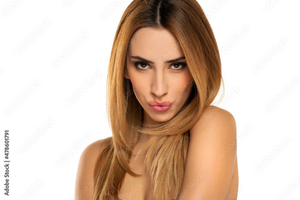 portrait of a young woman with long straight hair and kissing gesture on a white background portrait of a young woman with long straight hair and kissing gesture on a white background