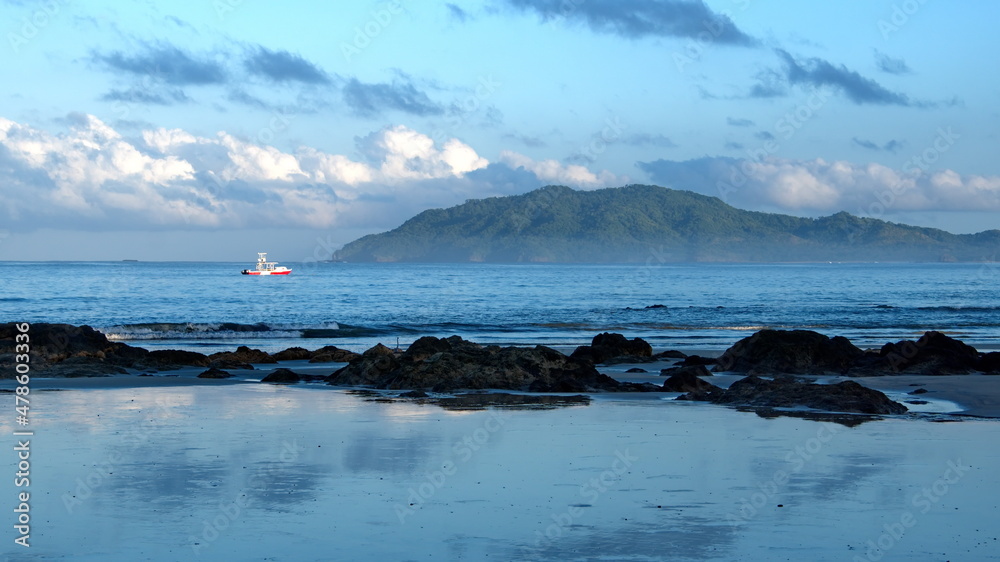 Boat moored off a rugged section of the beach in Tamarindo, Costa Rica
