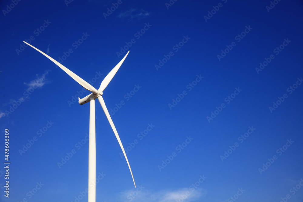 Wind Turbine generate electrical power, Green energy and environment concpet, huge white wind turbine aginst blue sky Wind Turbine generate electrical power, Green energy and environment concpet, huge white wind turbine aginst blue sky
