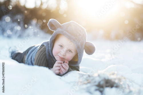 A two-year-old boy in a grey plush hood with ears.