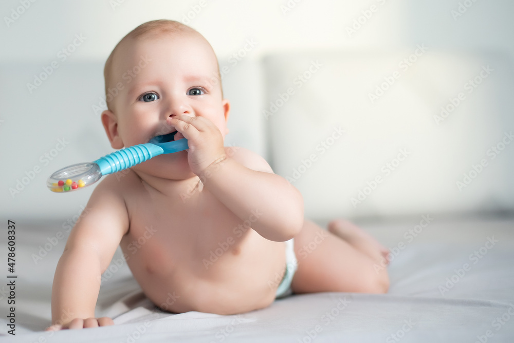 Cute smiling baby on a gray couch Cute smiling baby on a gray couch