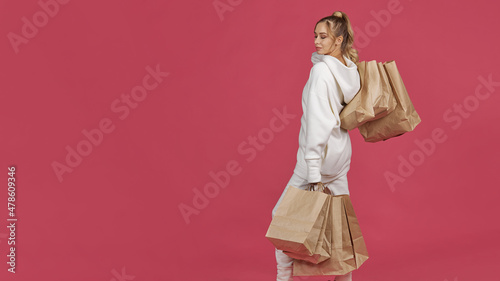 young woman posing with paper bags