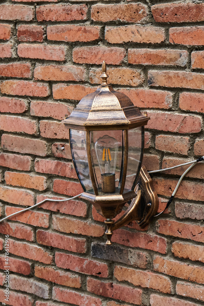 Vintage lantern on brick wall background