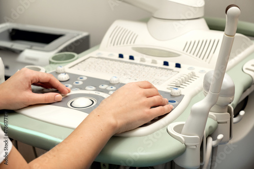 The hands of a doctor in close-up, making a diagnosis on an ultrasound machine.Medicine and healthcare concept.Selective focus.