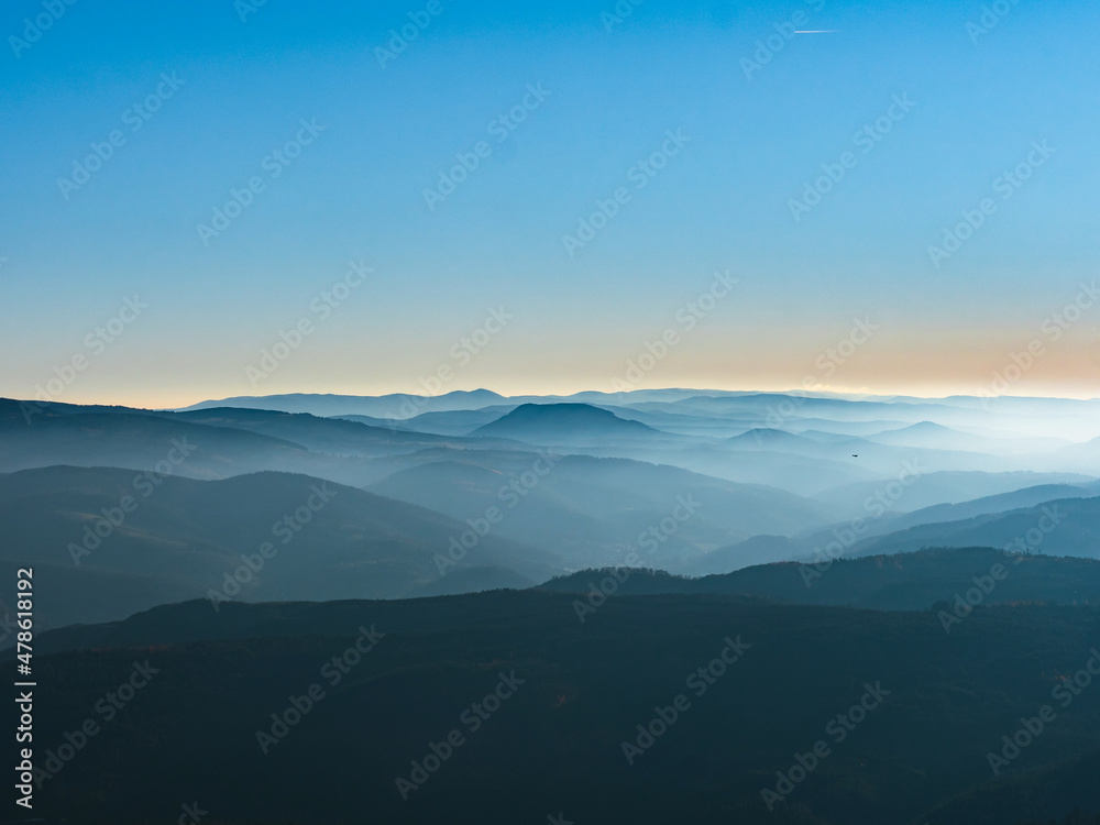  White snow and blue sky. Panoramic view of the silhouettes of the mountains.
