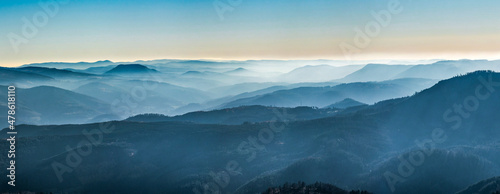  White snow and blue sky. Panoramic view of the silhouettes of the mountains.