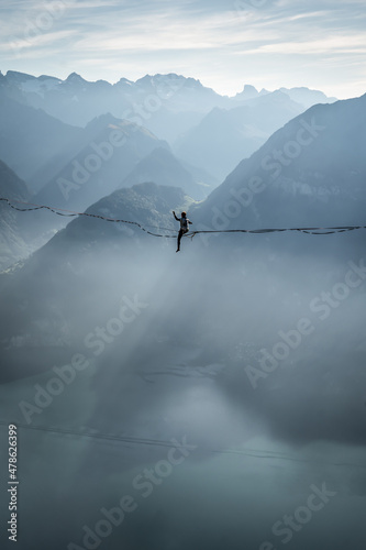 woman on slackline in mountains photo