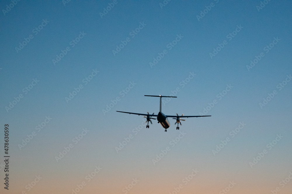 plane lands in the sunset