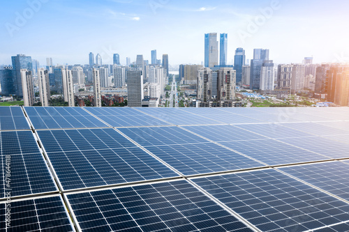 Canvas Print Photovoltaic panels in front of city background