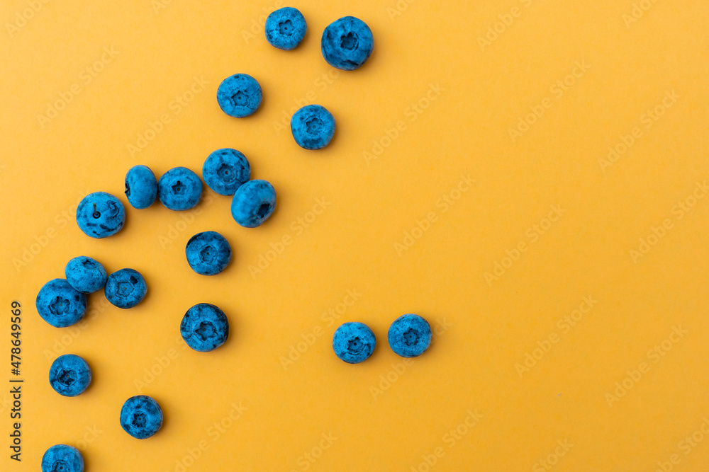 Trendy seamless pattern of blueberries. Blueberry pattern isolated on yellow background Trendy seamless pattern of blueberries. Blueberry pattern isolated on yellow background