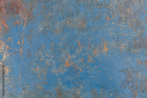An old wooden wall with dirt and scratches, covered with blue paint. Background, texture.