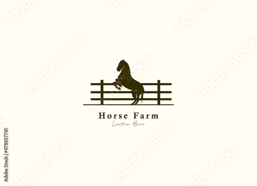 Horse silhouette behind wooden fence paddock for vintage retro rustic countryside western country farm ranch logo design