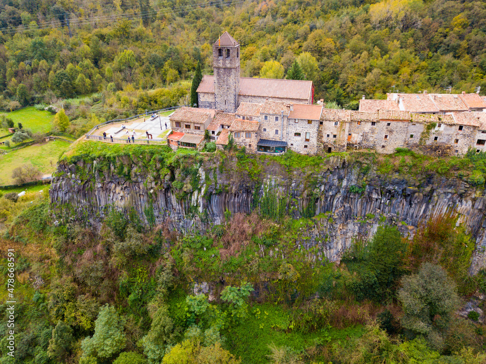 Aerial view of small ancient village of Castellfollit de la Roca located on edge of cliff, Catalonia, Spain