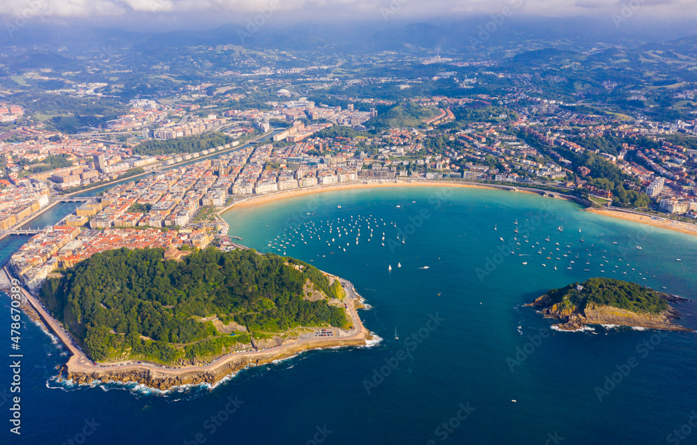 Scenic view from drone of Spanish town of San Sebastian (Donostia) on southern coast of Bay of Biscay on sunny summer day, Basque Country..