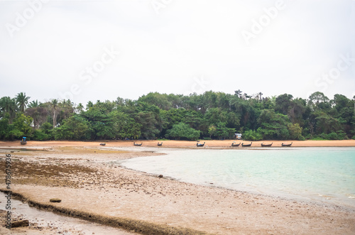 Sea coast with small fisherman boat on sand beach and tree background. nature landscape view island. ocean Thailand. tourism tropical outdoor vacation travel summer holidays concept.