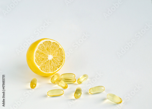 Lemon and pills on a white background