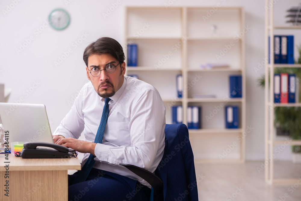 Young male bookkeeper in budget planning concept