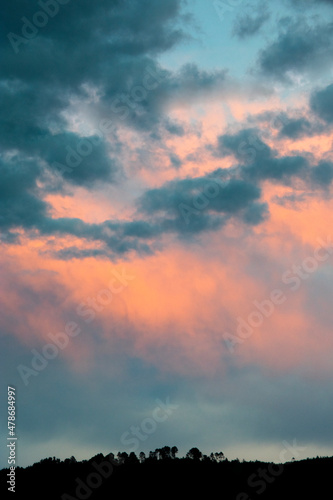 Dramatic sunset in rural Guatemala, silhouettes of mountains and colorful sky in clouds of January 2022.