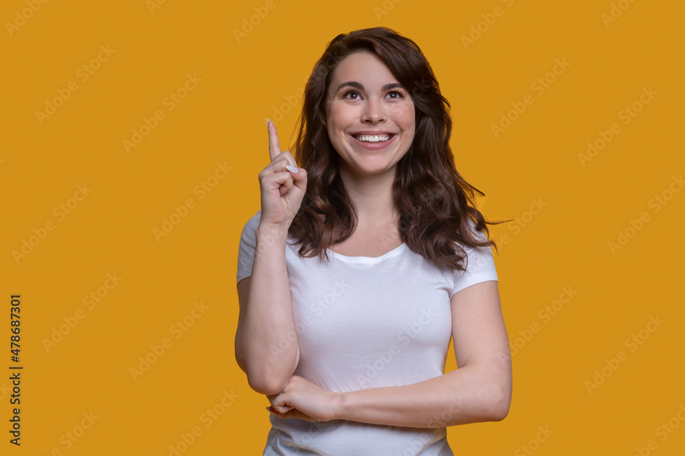 Cheerful female holding up her index finger Cheerful female holding up her index finger