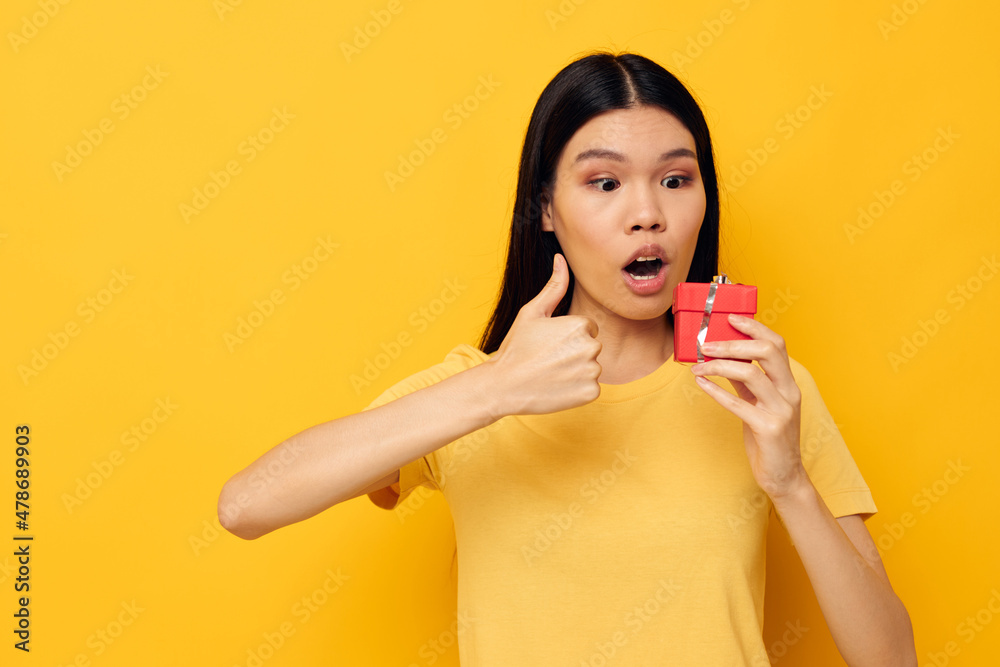 Charming young Asian woman Little red gift box fun studio model unaltered