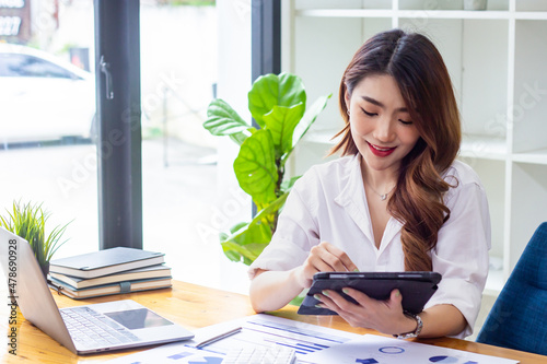 Businesswoman analyzing company sales data for the past year, woman looking at financial documents on tablet, accountant checking company numbers, new business concept.