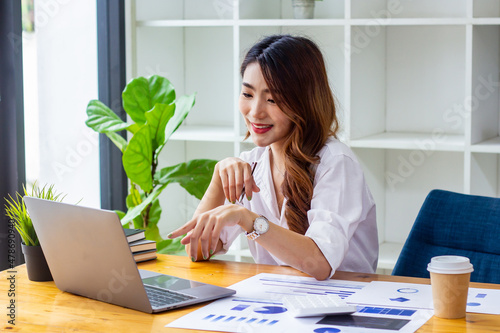 Businesswoman discussing company sales data last year at computer, woman looking at financial documents on computer, accountant checking company numbers, new business concept.