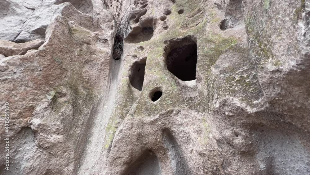 Tilt up vertical canyon wall caves in Bandelier National Monument Stock