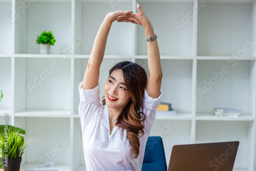 Businesswoman meditating and doing yoga due to fatigue from checking company balances, new business ideas.