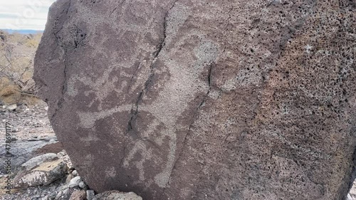 Ancient indigenous petroglyphs on rock in Bandelier National Monument photo
