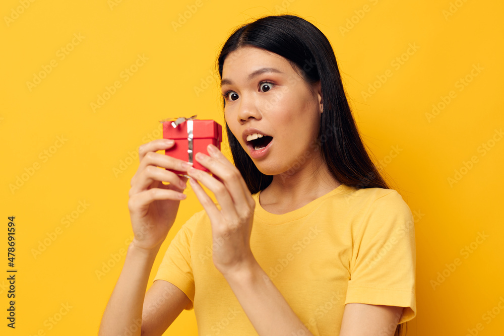 pretty brunette in a yellow t-shirt holiday gift emotions Lifestyle unaltered pretty brunette in a yellow t-shirt holiday gift emotions Lifestyle unaltered