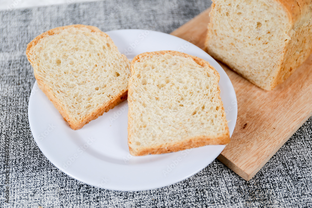 Wheat bread loaf on a white background.