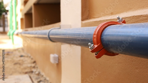 Grooved Coupling on plumbing pipes. Syler plumbing pipe connected with coupling on the side of the building with copy space. Selective focus
