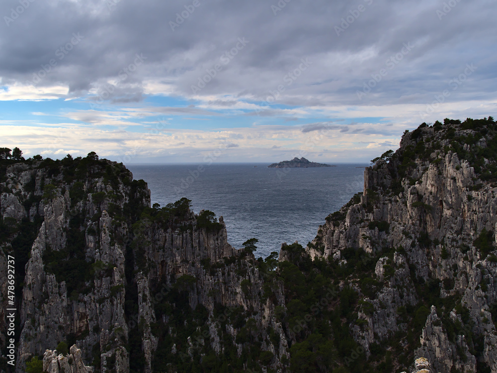 Beautiful view of the rugged cliffs of mountain range Massif des Calanques near Cassis at the French Riviera on cloudy day in autumn season.