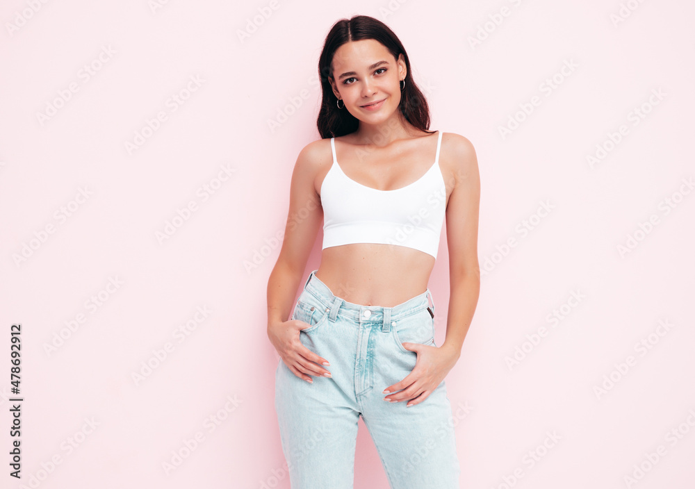 Young beautiful smiling female in trendy summer clothes. carefree woman posing near pink wall in studio. Positive brunette model having fun and going crazy. Cheerful and happy Young beautiful smiling female in trendy summer clothes. carefree woman posing near pink wall in studio. Positive brunette model having fun and going crazy. Cheerful and happy