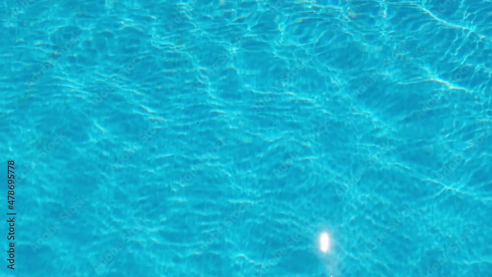 Water drop in swimming pool. Blue color. Ocean lockdown surface. Stop motion video. H2O hotel relax. Sea summer texture. Crystal wet waves. Float calm splash. Nobody liquid background Water drop in swimming pool. Blue color. Ocean lockdown surface. Stop motion video. H2O hotel relax. Sea summer texture. Crystal wet waves. Float calm splash. Nobody liquid background