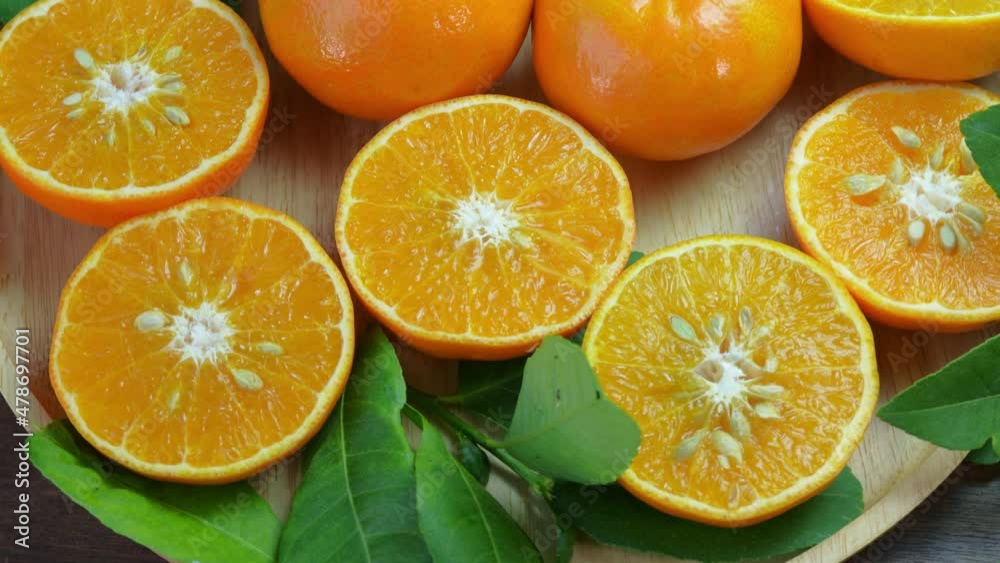 Tangerine Taiwan Orange with slices on wooden, Mandarin Orange fruit in wooden basket on wooden table in garden. Tangerine Taiwan Orange with slices on wooden, Mandarin Orange fruit in wooden basket on wooden table in garden.