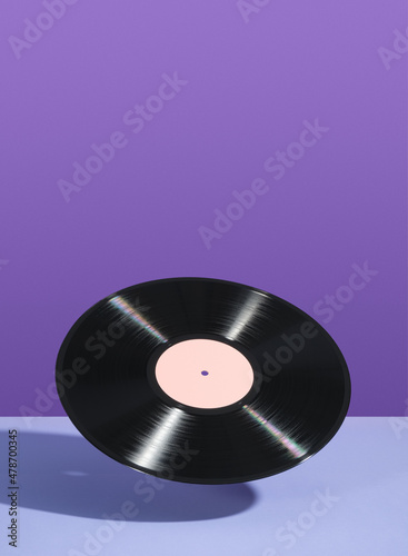Retro vinyl record float in the air. Copy space for text. Idea of vintage parties and music.