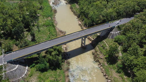 A vehicular traffic bridge over a large river in Yogyakarta, Indonesia photo