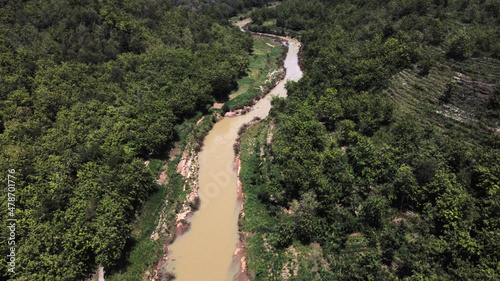 Aerial view of a river in the middle of a forest in a mountainous area in Yogyakarta © SetianingDyah