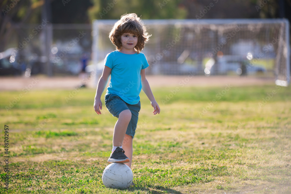 Soccer kids, child boy play football outdoor. Young boy with soccer ball doing kick. Football soccer players in motion. Cute boy in sport action. Boy kicking football on the field. Soccer kids, child boy play football outdoor. Young boy with soccer ball doing kick. Football soccer players in motion. Cute boy in sport action. Boy kicking football on the field.