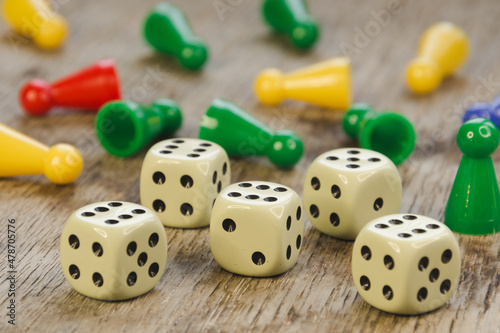 Colorful play figures with group of dice on board