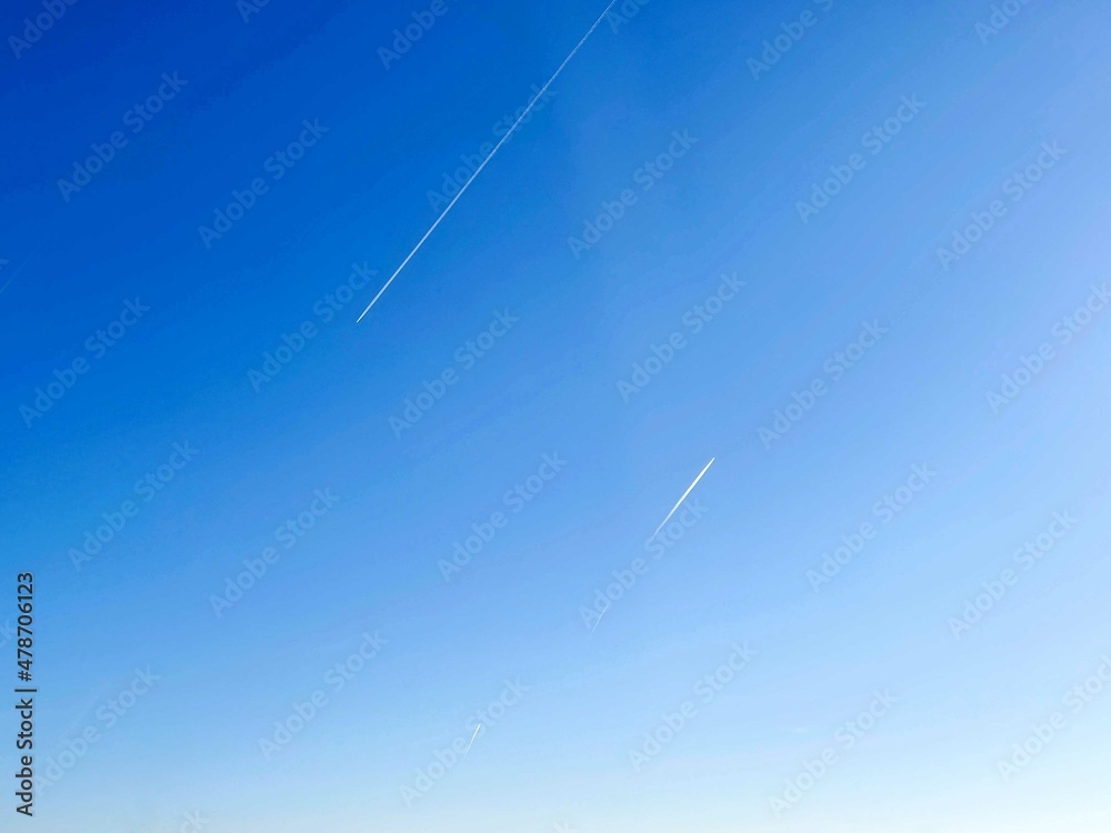 Airplanes going to different directions in the blue sky Airplanes going to different directions in the blue sky