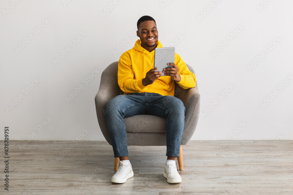 African American Man Using Tablet Browsing Internet On Gray Background African American Man Using Tablet Browsing Internet On Gray Background