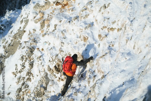 People hiking in beautiful winter mountains for winter sport activity snow mountain hills. Winter hiking cold weather with backpack on snow trail forest. Man with backpack trekking in mountains