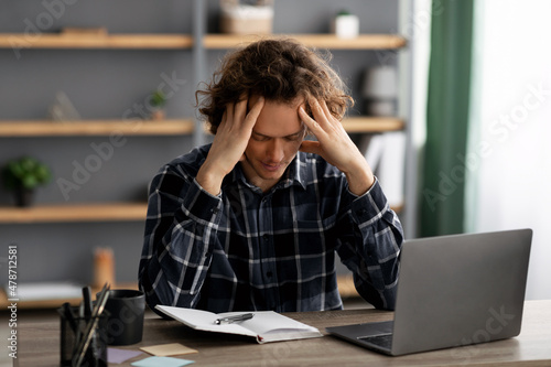 Unhappy Businessman Touching Head Having Problem At Workplace